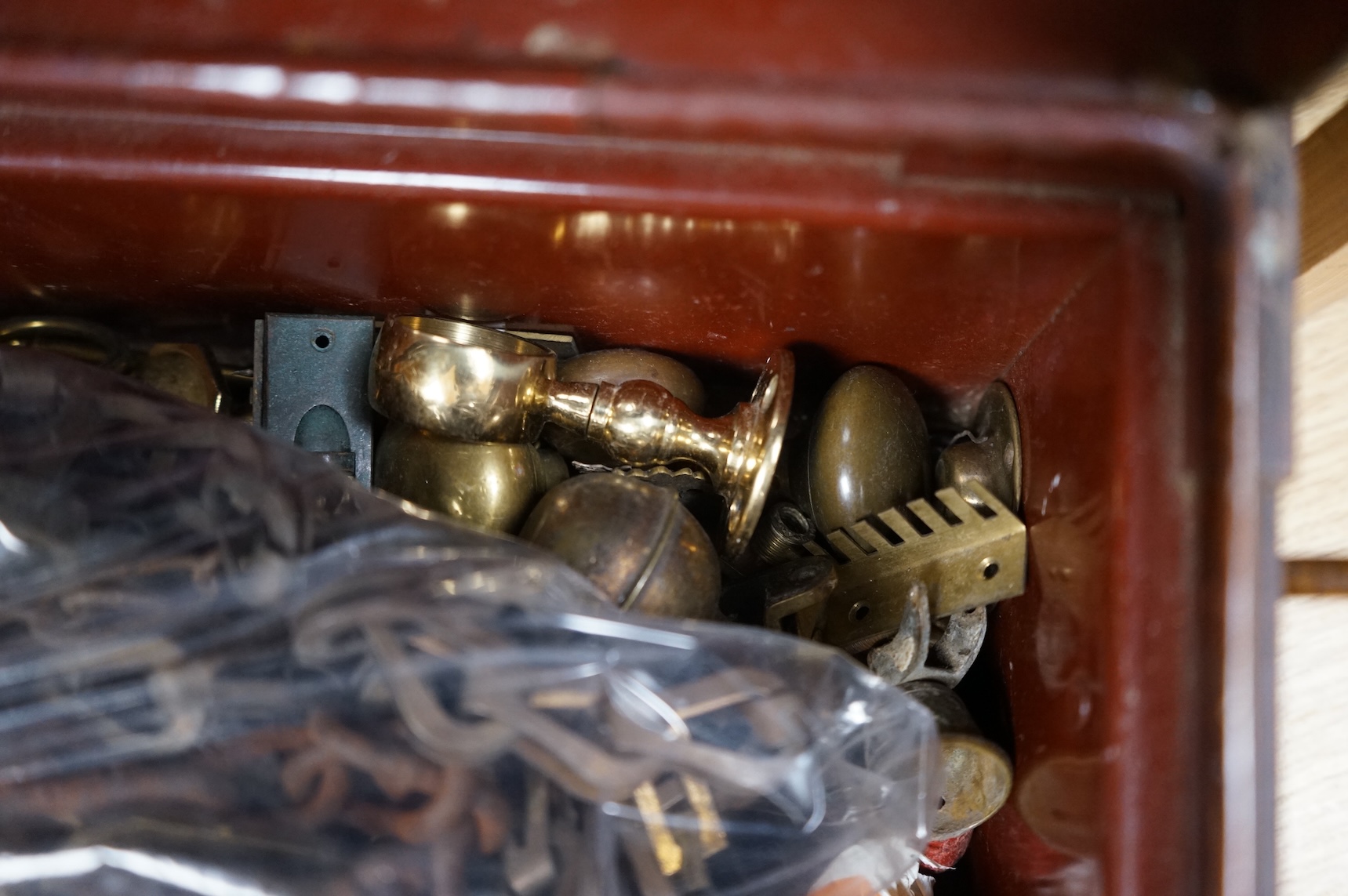 A brush grained tin trunk containing brass furniture mounts and fittings and a micromosaic miniature photo frame and hand mirror, trunk 47cm wide (a.f.)